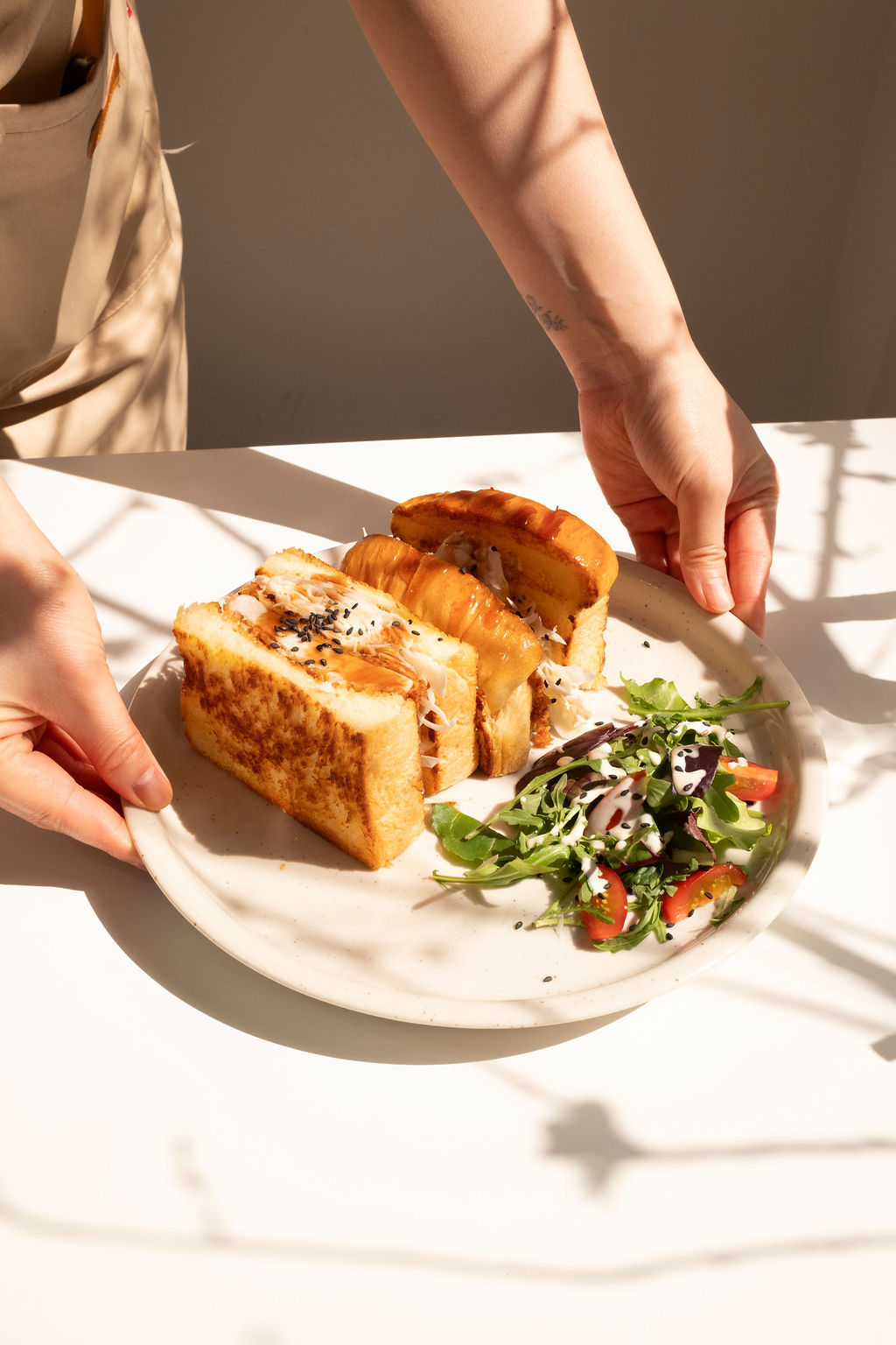Thick, juicy Iberico pork katsu cutlet sandwhich with shaved cabbage on pristine white shokupan