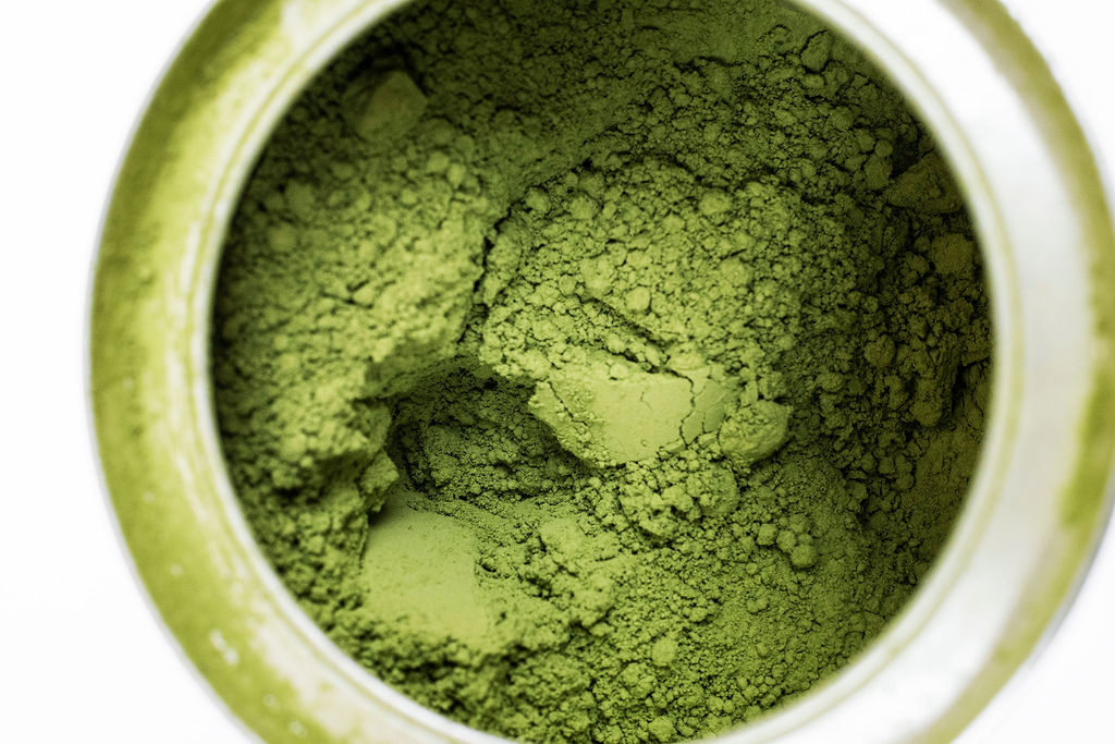 Vivid green fine matcha powder macro texture